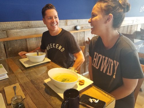 woman and men sitting on table and dining